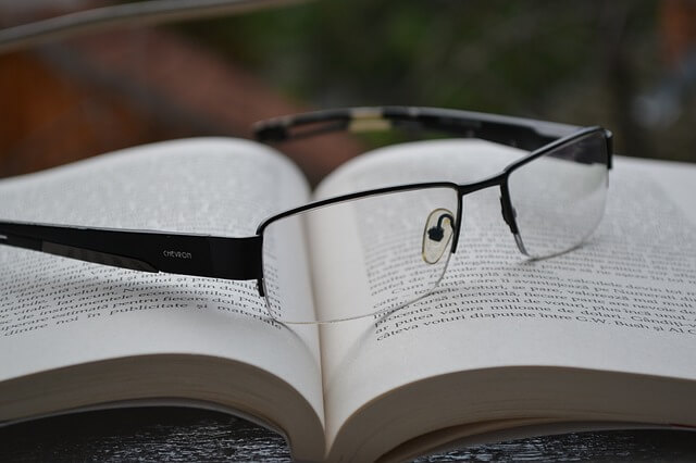 a pair of eyeglasses on an open book